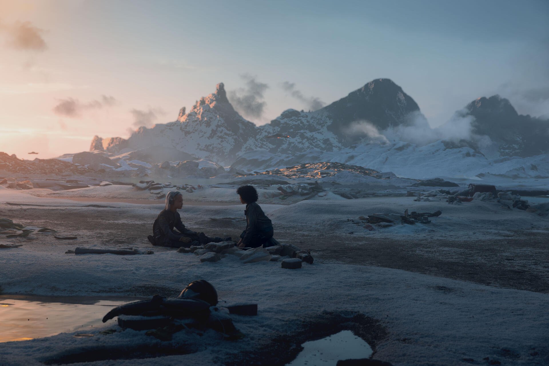 A stunning 8K Ultra HD backdrop from the TV show Star Wars: Skeleton Crew, featuring two characters sitting on a snowy landscape with dramatic mountains in the background at sunset.