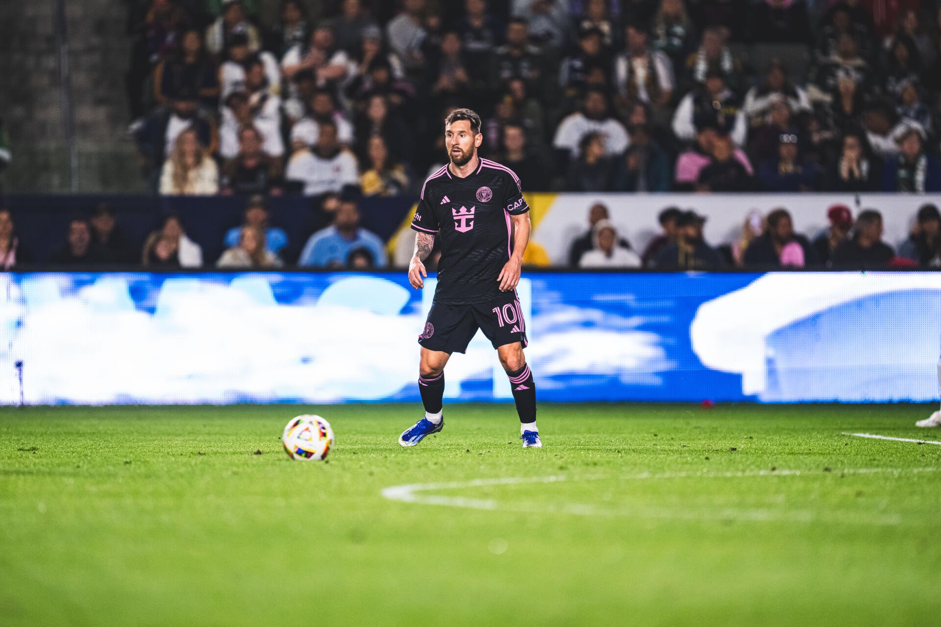 Lionel Messi in action for Inter Miami CF, showcasing his skills on the field during a vibrant soccer match, surrounded by enthusiastic fans. 8K Ultra HD resolution.