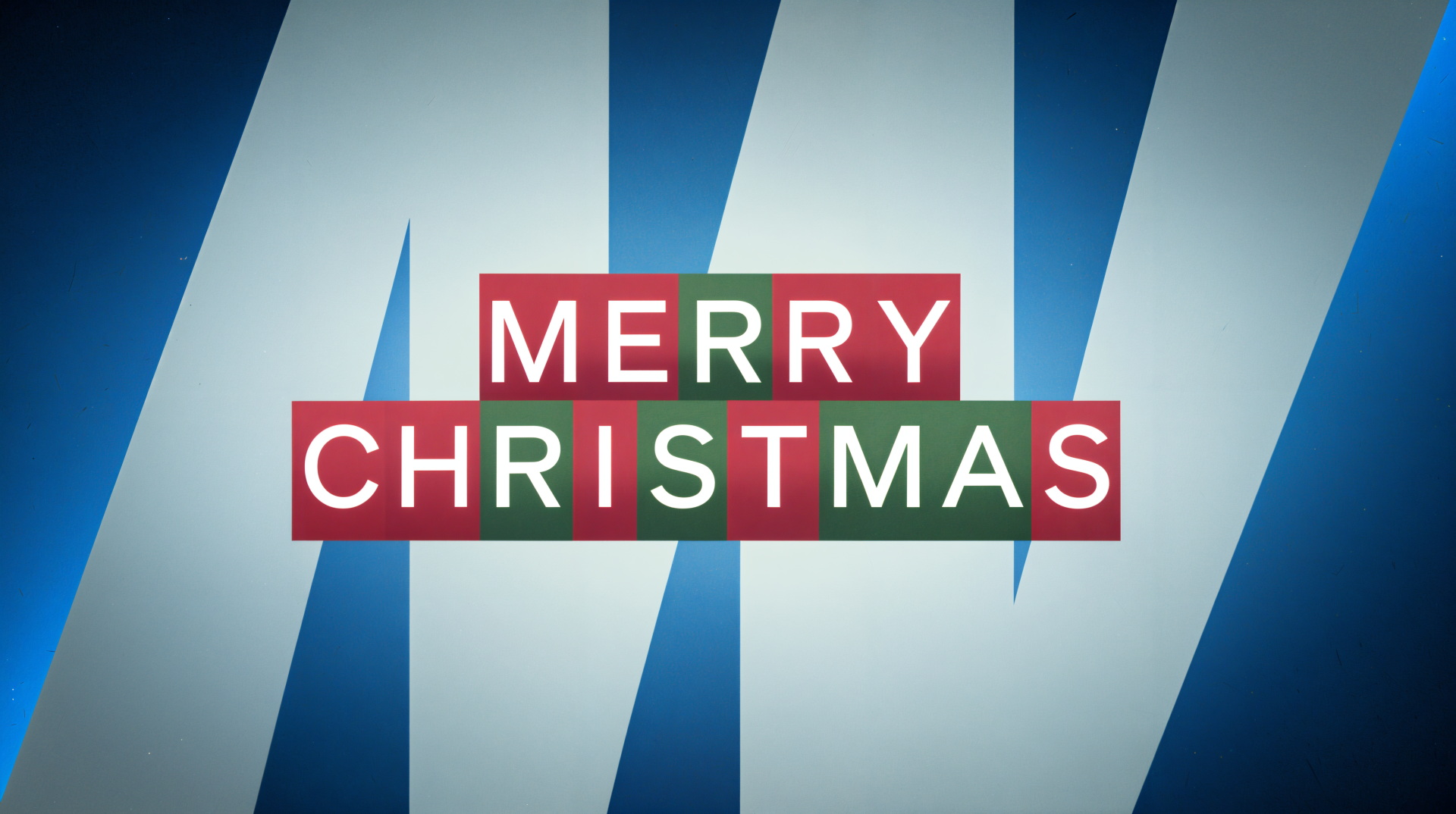A vibrant 4K Ultra HD desktop wallpaper featuring the festive text Merry Christmas in bold, colorful letters against a modern blue background.