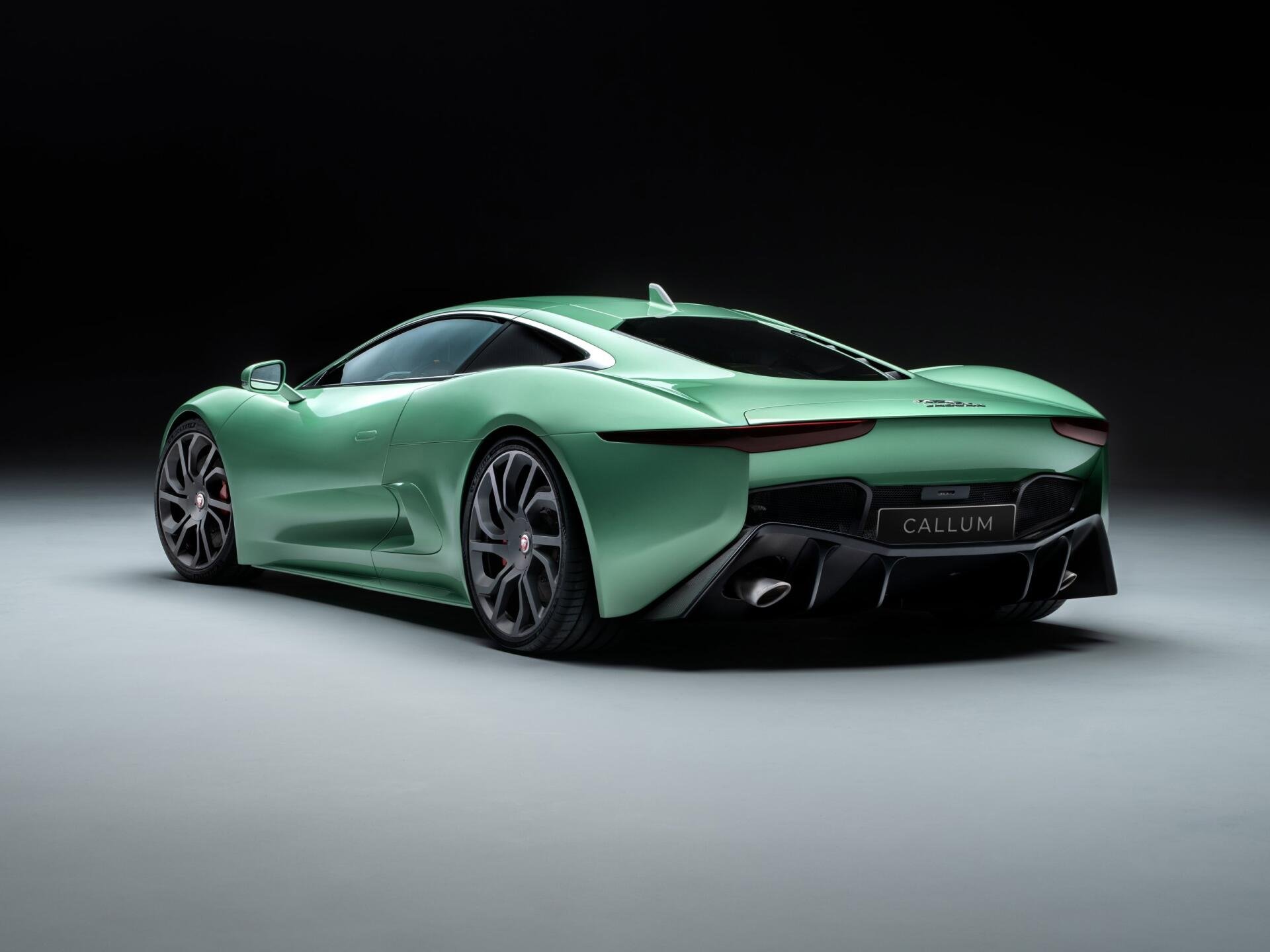 A sleek Jaguar C-X75 in a vibrant green hue, showcased against a dark background, serves as an impressive high-definition PC desktop wallpaper.