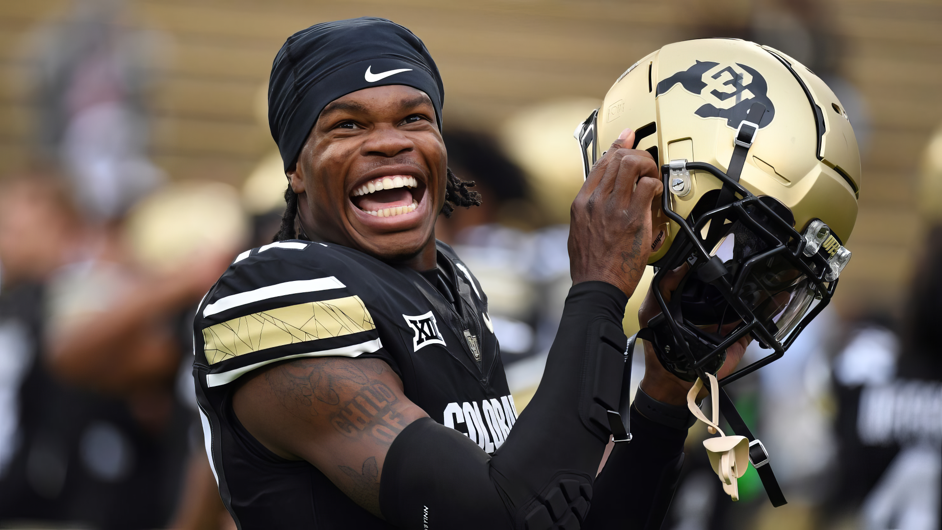 Travis Hunter of the Colorado Buffaloes proudly displays his football helmet, showcasing his enthusiasm and team spirit in this HD desktop wallpaper.