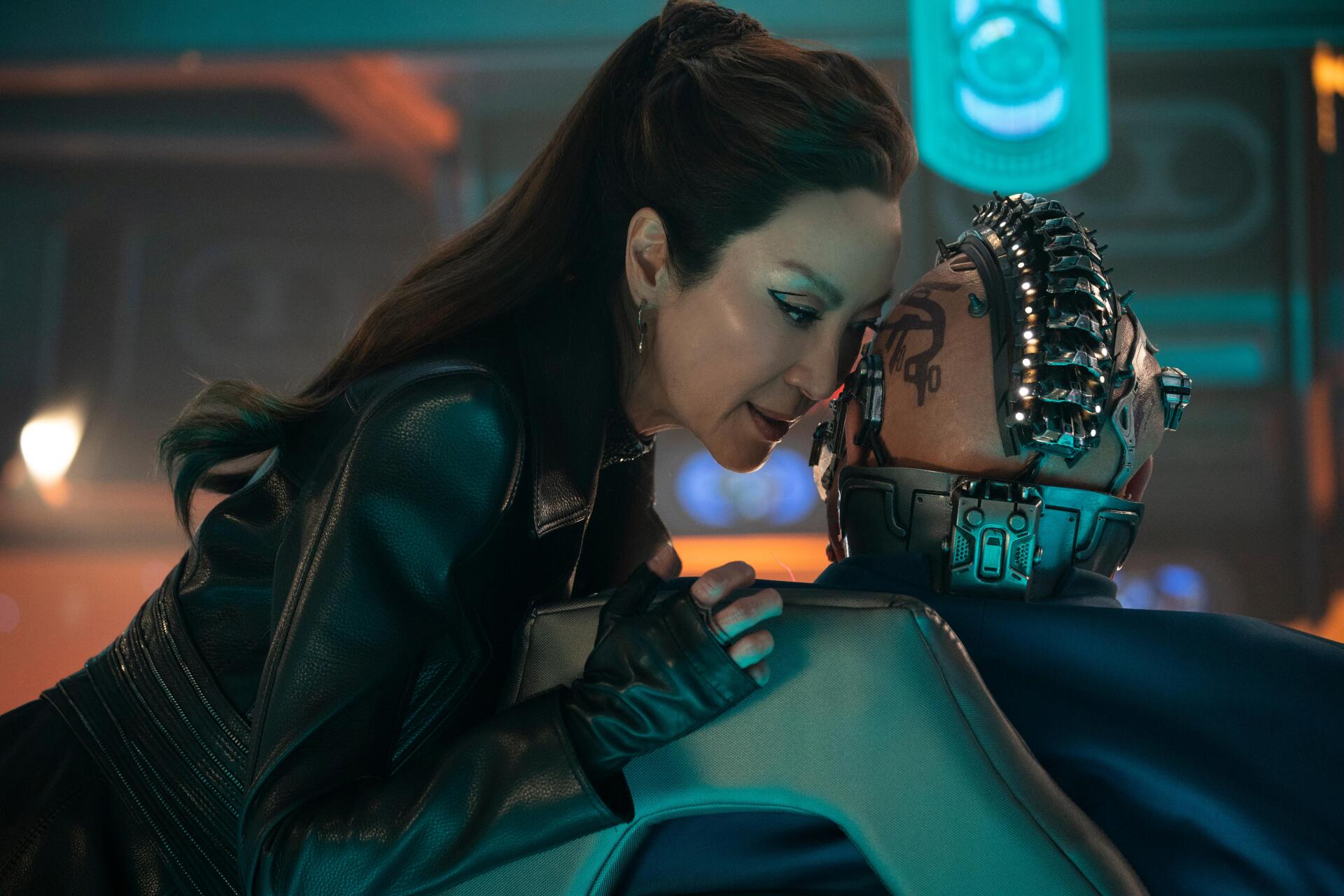 A scene from Star Trek: Section 31 featuring Michelle Yeoh in a futuristic setting, engaging with a character with cybernetic implants, captured in vibrant 4K Ultra HD.
