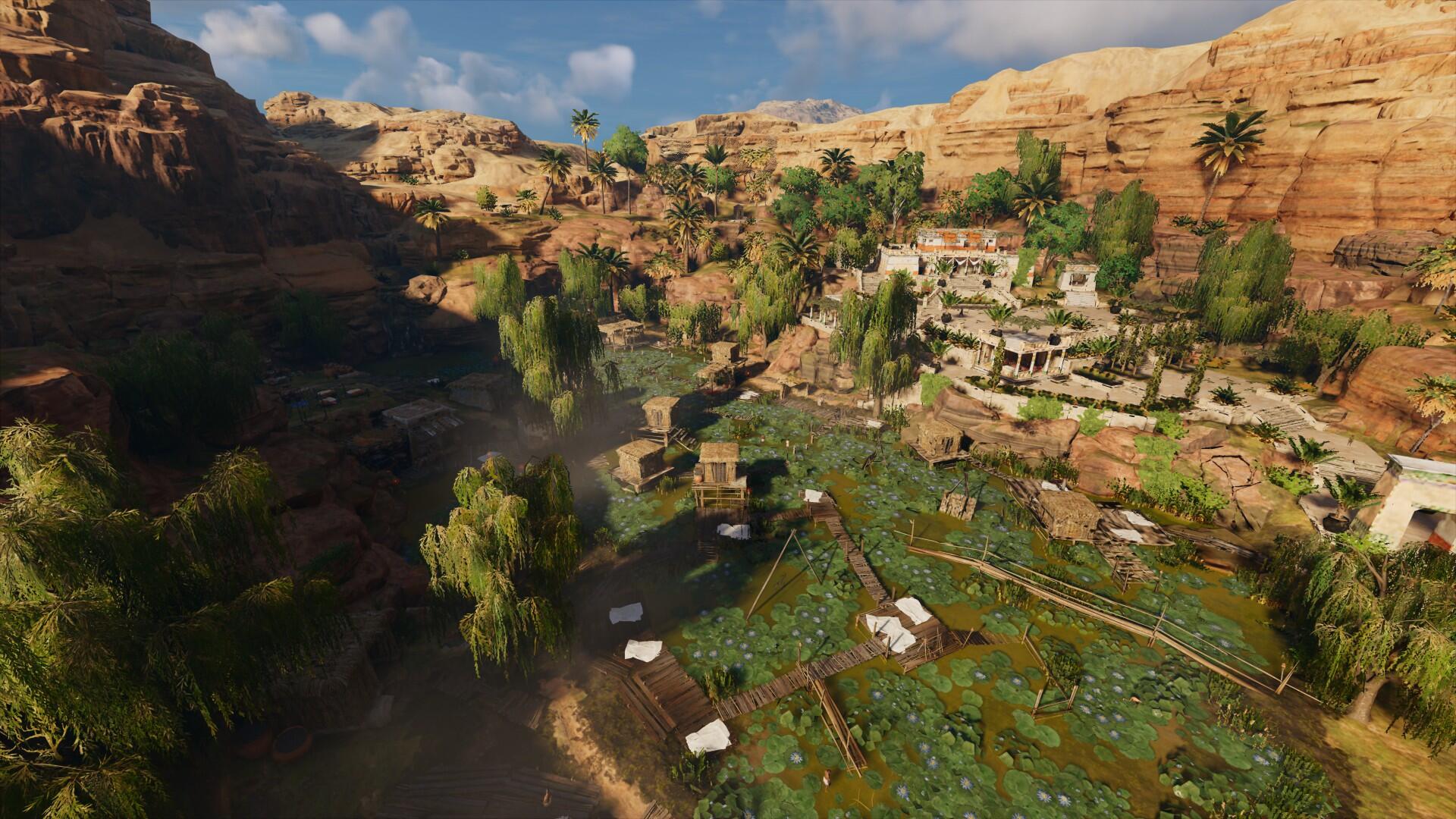 A stunning HD PC desktop wallpaper from Assassin's Creed Origins, showcasing a vibrant landscape with lush greenery and ancient structures set against a mountainous backdrop.