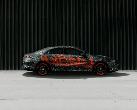 A sleek Mercedes-Benz CLA showcased in a striking design, featuring bold graphics. This HD image makes for an impressive desktop wallpaper and background.