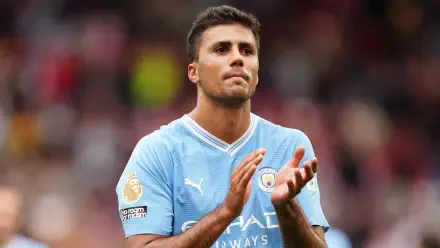 Rodri Hernández of Manchester City F.C. claps during a match, captured in this HD desktop wallpaper, showcasing his dedication on the soccer field.