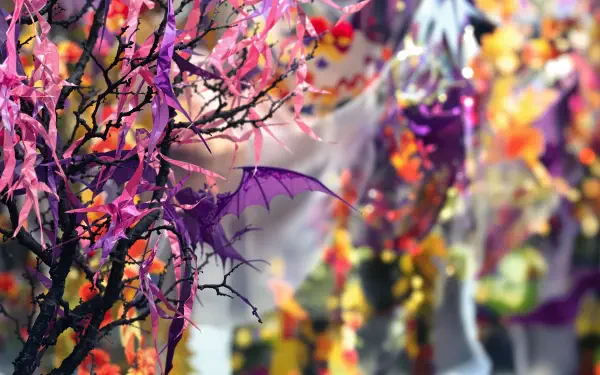 A vibrant Halloween decoration scene featuring purple bat wings and colorful foliage, creating an enchanting atmosphere. This 4K Ultra HD wallpaper enhances your desktop background.