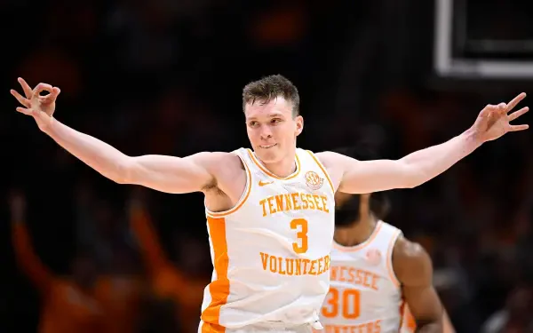 Dalton Knecht celebrates during a basketball game, showcasing his skills in a dynamic pose, wearing the Tennessee Volunteers uniform. A vibrant image capturing sports energy.