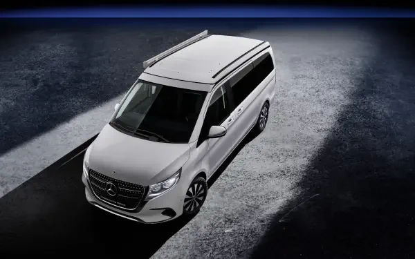 A sleek Mercedes-Benz V-Class Marco Polo is showcased in a dramatic 4K Ultra HD setting, highlighting its modern design and features against a striking background.