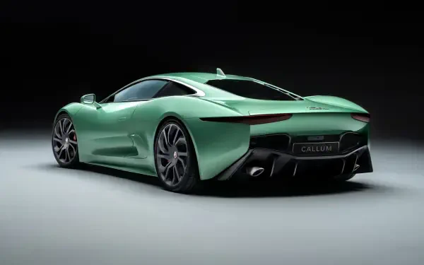 A sleek Jaguar C-X75 in a vibrant green hue, showcased against a dark background, serves as an impressive high-definition PC desktop wallpaper.