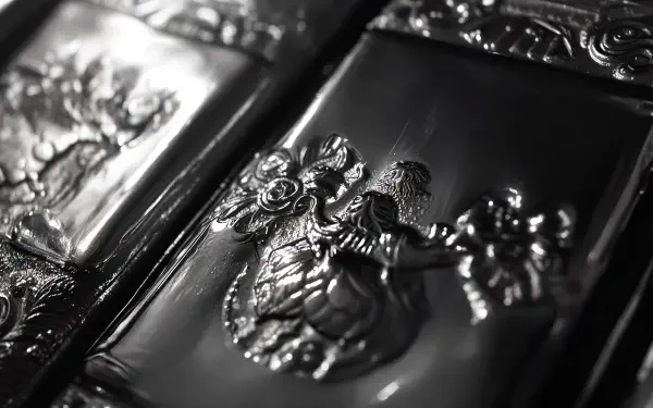 Close-up of intricately designed silver bars showcasing artistic embossing, set against a sleek background, perfect as a striking 4K Ultra HD PC desktop wallpaper.