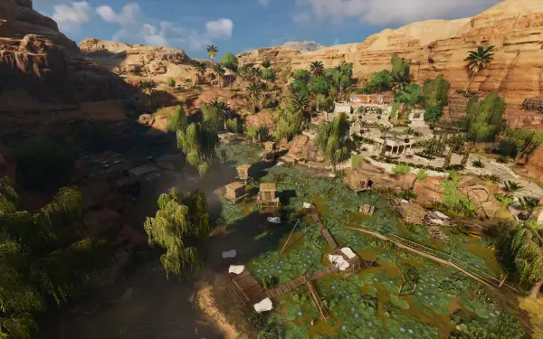A stunning HD PC desktop wallpaper from Assassin's Creed Origins, showcasing a vibrant landscape with lush greenery and ancient structures set against a mountainous backdrop.
