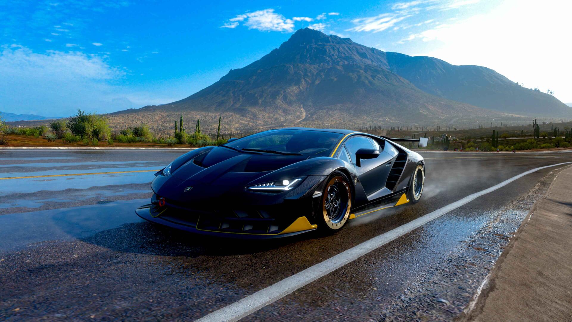4K Ultra HD PC desktop wallpaper/background featuring a black Lamborghini car on a wet road with a rugged mountain backdrop and vivid blue sky.