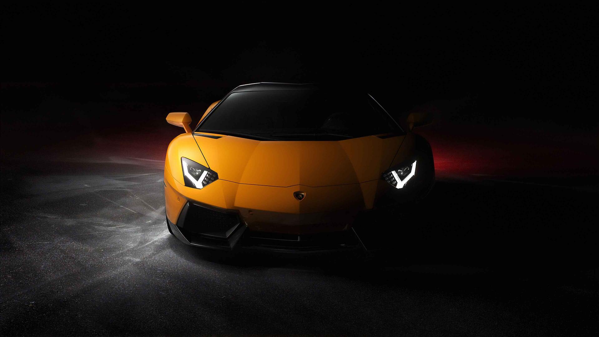 Front view of a yellow Lamborghini sports car in dramatic low light, high-resolution 4K Ultra HD PC desktop wallpaper and background.