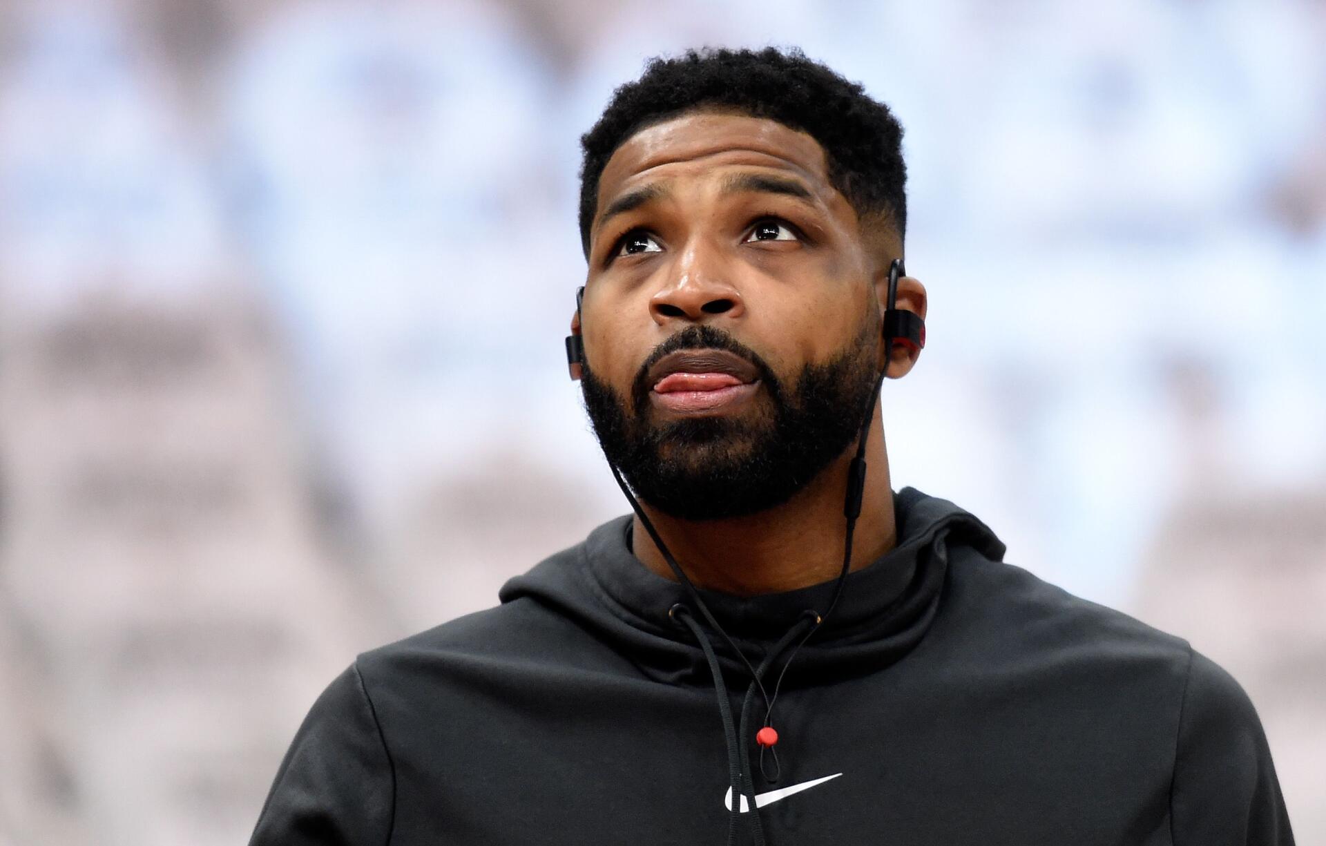 Tristan Thompson, focused and wearing headphones, glances upward during an NBA event. This high-definition image serves as a striking PC desktop wallpaper.