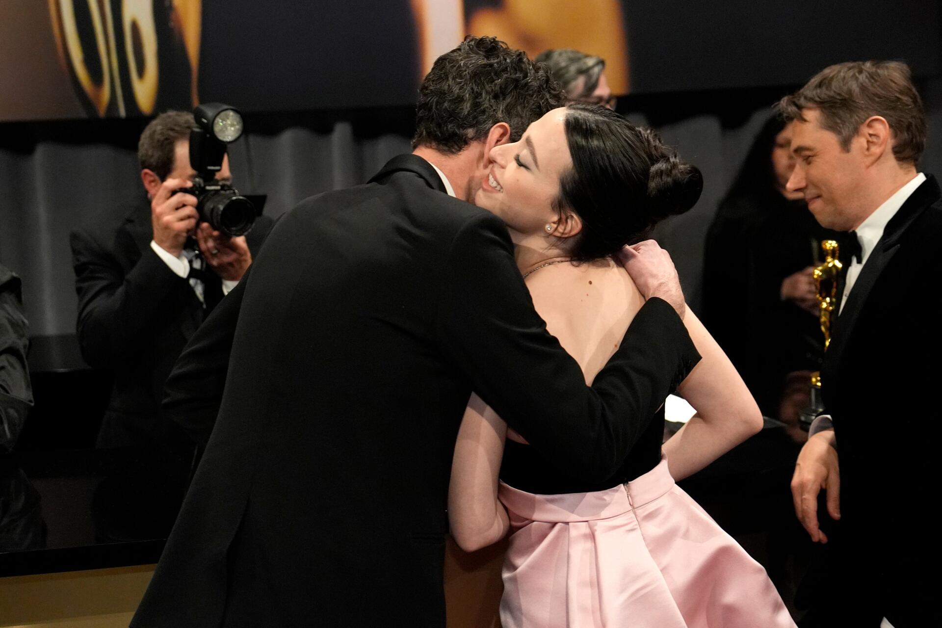 Mikey Madison shares a joyful hug at the Academy Awards, captured in this vibrant 4K Ultra HD desktop wallpaper showcasing a celebratory moment.