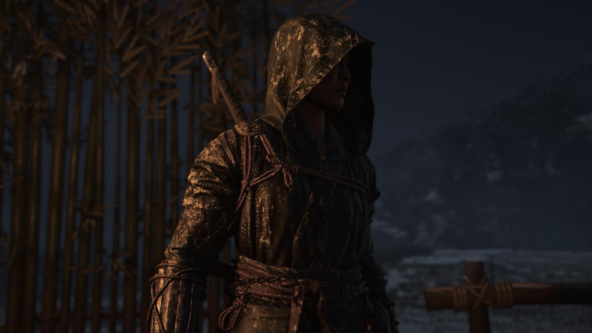 A character from Assassin's Creed Shadows stands cloaked and mysterious in a dark, atmospheric setting, creating an immersive 4K Ultra HD wallpaper for PC desktops.