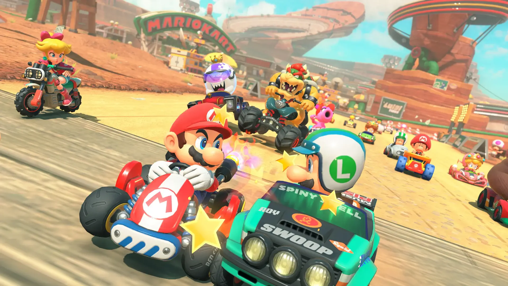 A vibrant 4K Ultra HD Mario Kart world scene showing Mario and other characters racing in karts on a desert-themed track, designed as a PC desktop wallpaper.