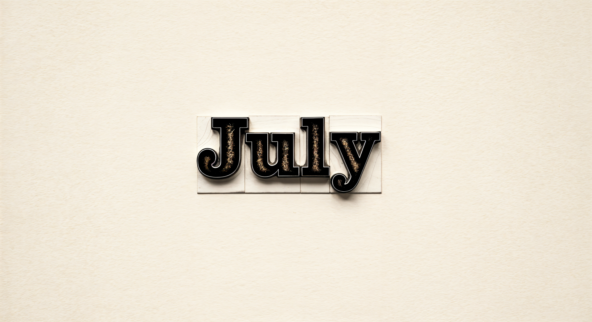 4K Ultra HD PC desktop wallpaper featuring the word July in black letterpress type on a light beige background.