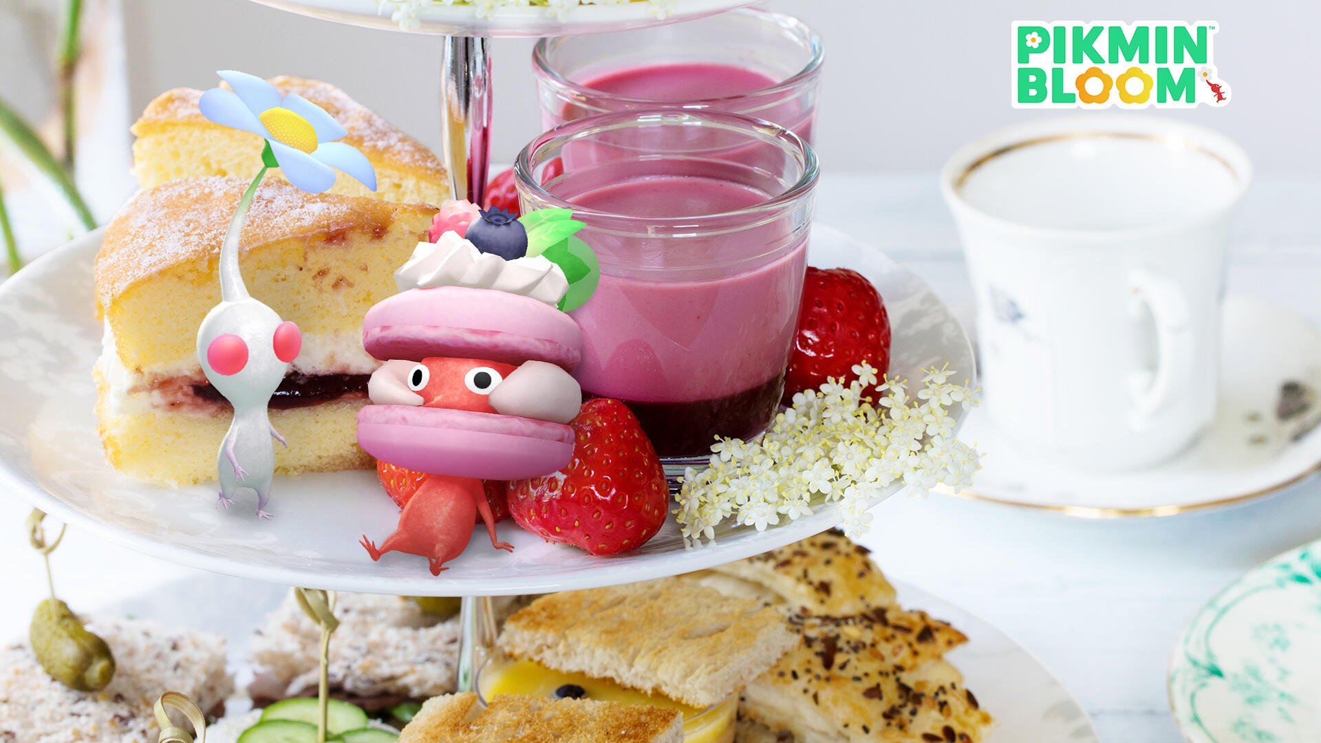HD PC desktop wallpaper featuring a Pikmin character styled as a dessert among colorful cakes, fruits, and drinks, with a Pikmin Bloom logo in the corner.