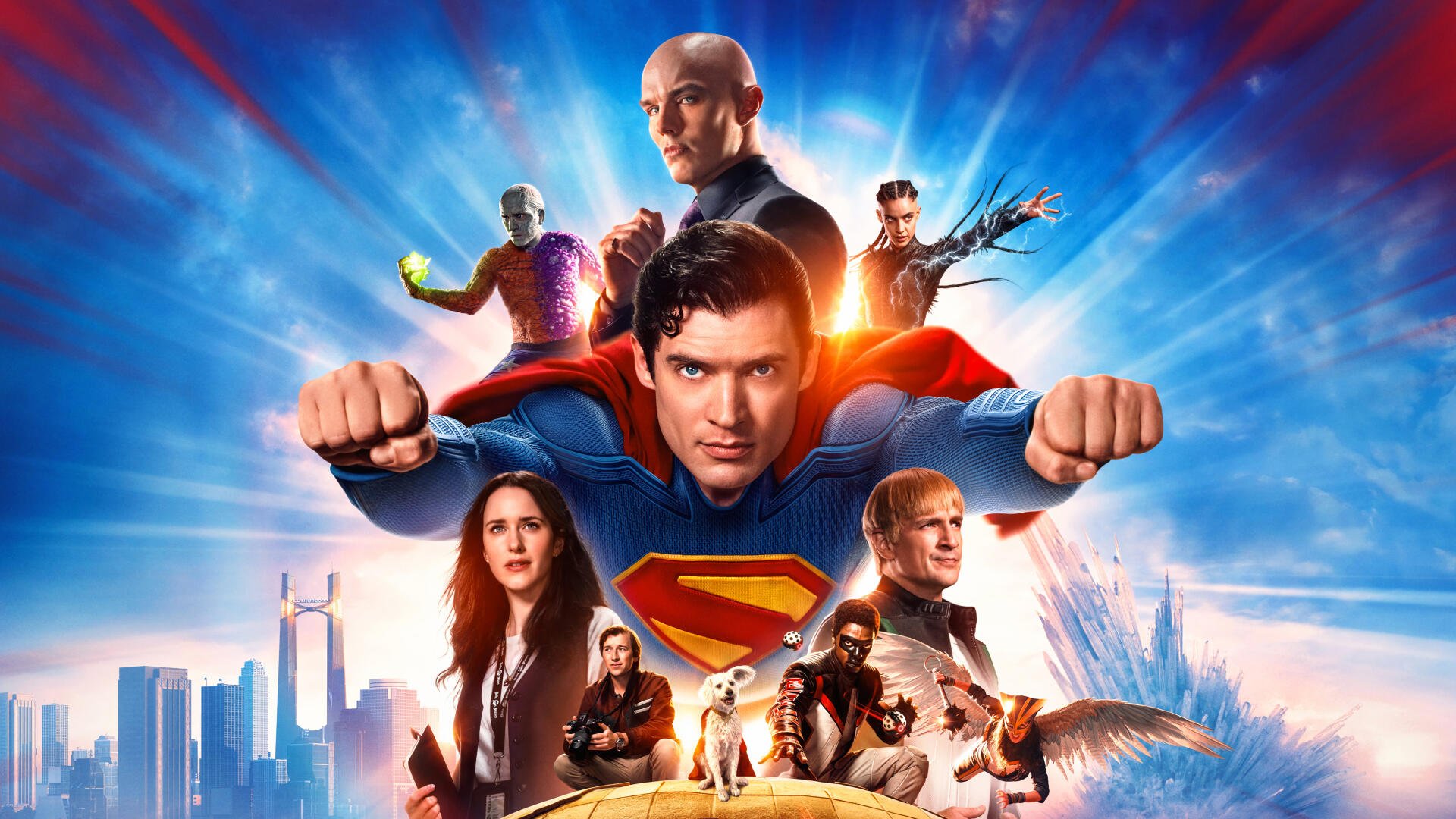 4K Ultra HD PC desktop wallpaper featuring Superman (2025) in a dynamic heroic pose surrounded by key characters against a vibrant cityscape and radiant sky.