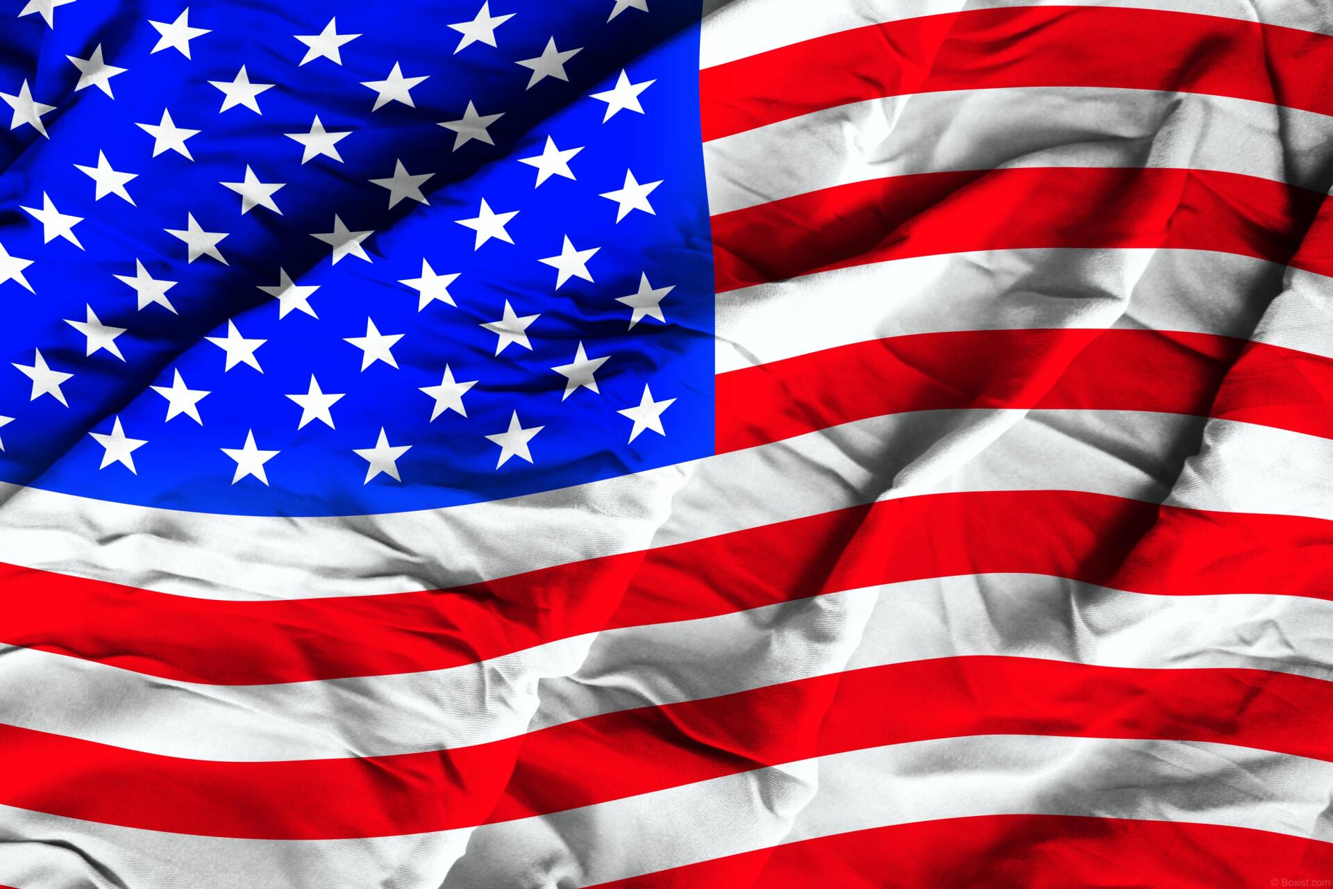 Crumpled silk United States flag with stars and stripes, vibrant HD 4th of July desktop wallpaper.