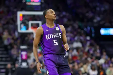 De'Aaron Fox of the Sacramento Kings on the court, wearing a purple jersey with the number 5. The vibrant background is filled with a cheering crowd, capturing the excitement of NBA basketball.