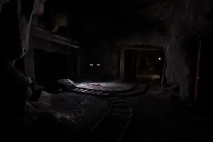 A dark, atmospheric scene from Poppy Playtime: Chapter 4 features a dimly lit environment with a winding track and eerie shadows, creating a sense of suspense and intrigue.