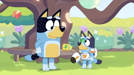 An HD desktop wallpaper featuring characters from the TV show Bluey, showing a playful scene under a tree with two animated dogs engaged in imaginative play.