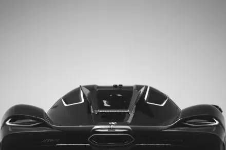 A sleek Koenigsegg Jesko Absolut is showcased with dynamic lines, set against a minimalist background, presented as an 8K Ultra HD desktop wallpaper.