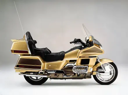 A sleek 25YM Honda GL 1800 Gold Wing motorcycle in stunning gold finish, showcased against a neutral background, designed as a 4K Ultra HD PC desktop wallpaper.
