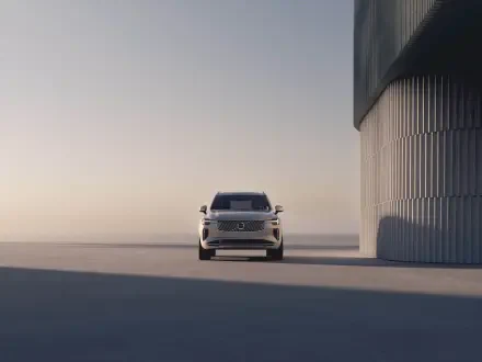 A sleek Volvo XC90 Facelift stands prominently in a minimalist setting, showcasing its modern design and elegance against a soft, light-filled backdrop.
