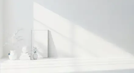 Minimalist white aesthetic interior with natural light streaming in, featuring simple home decor elements against a clean, bright backdrop.