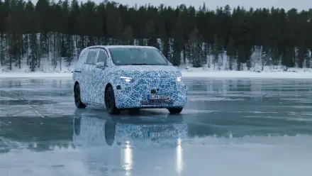 A Mercedes-Benz MPV is seen on a frozen lake, showcasing a camouflaged design against a backdrop of snowy trees. This striking image serves as a 4K Ultra HD desktop wallpaper.