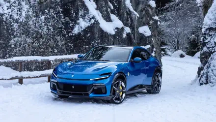 A stunning blue Ferrari Purosangue parked in a snowy landscape, showcasing its sleek design. This image serves as an 8K Ultra HD PC desktop wallpaper.