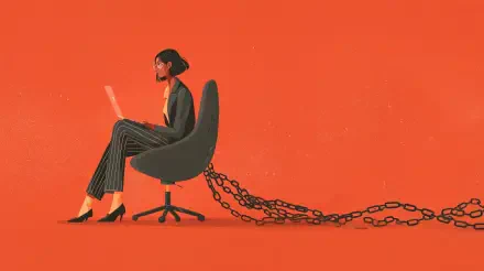 A woman in business attire works on a laptop, seated in an office chair with heavy chains attached, symbolizing the constraints of a 9 to 5 job.