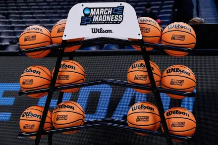 HD basketball wallpaper showing an NCAA March Madness rack filled with Wilson basketballs on a court background.