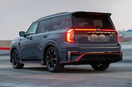 HD desktop wallpaper featuring a sleek Nissan Armada NISMO parked outdoors, showcasing its modern design and bold rear lighting.