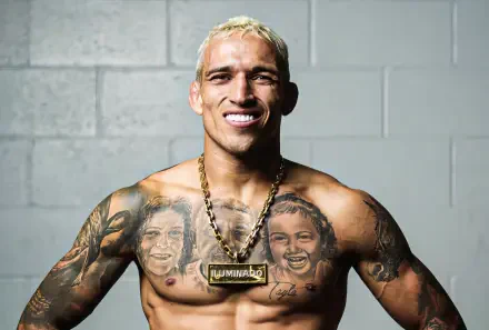 HD PC desktop wallpaper featuring UFC fighter Charles Oliveira smiling against a gray wall background.