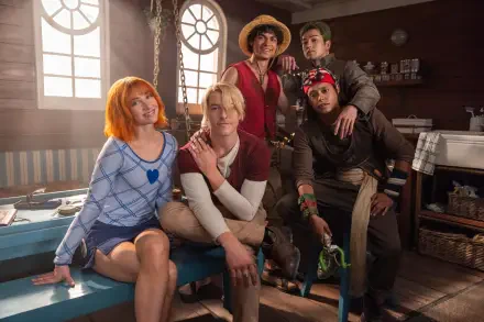HD PC desktop wallpaper of One Piece (Live Action): five characters pose in a sunlit ship cabin — straw hat centered, orange-haired woman, blonde and two men gathered casually.