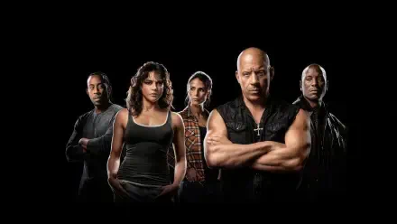 Five tense, muscular Fast X characters stand in a row against a black background, arms folded and serious faces — 4K Ultra HD PC Desktop Wallpaper and Background.