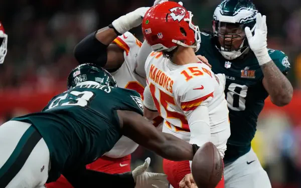 A dynamic moment from an NFL game featuring the Kansas City Chiefs and Philadelphia Eagles, showcasing intense action as players compete for control of the football.