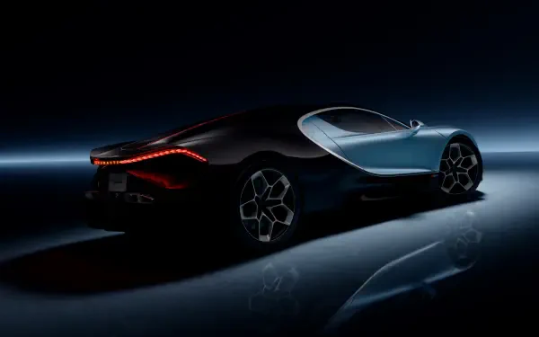 A sleek Bugatti hypercar, featuring striking lines and modern design, showcased in a dark setting with illuminated accents, perfect as a 4K Ultra HD desktop wallpaper.