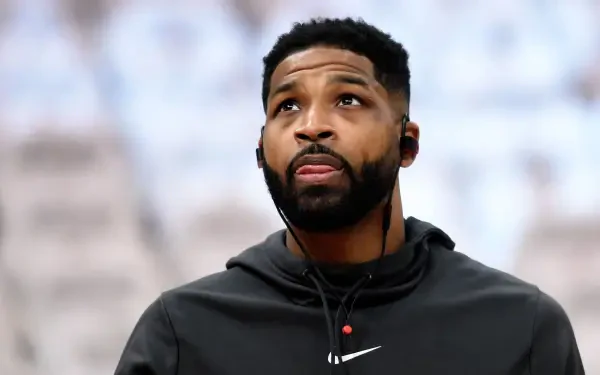 Tristan Thompson, focused and wearing headphones, glances upward during an NBA event. This high-definition image serves as a striking PC desktop wallpaper.
