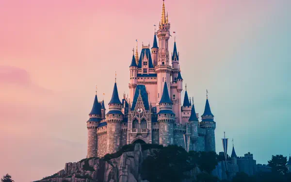 An enchanted castle rises majestically amid a serene landscape, showcasing intricate architecture under a soft, pastel sky. A stunning 4K Ultra HD wallpaper for a magical touch.