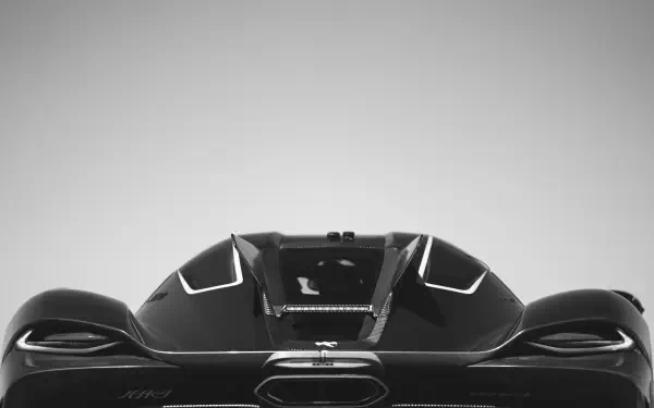 A sleek Koenigsegg Jesko Absolut is showcased with dynamic lines, set against a minimalist background, presented as an 8K Ultra HD desktop wallpaper.