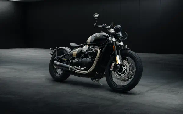 A sleek Triumph Bonneville Bobber TFC motorcycle showcased against a dark background, highlighted in a 4K Ultra HD resolution, emphasizing its modern design and craftsmanship.
