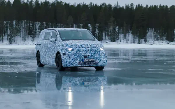 A Mercedes-Benz MPV is seen on a frozen lake, showcasing a camouflaged design against a backdrop of snowy trees. This striking image serves as a 4K Ultra HD desktop wallpaper.
