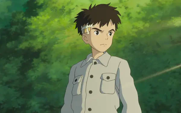 HD anime desktop wallpaper from The Boy and the Heron featuring a determined young boy standing against a lush green forest backdrop.