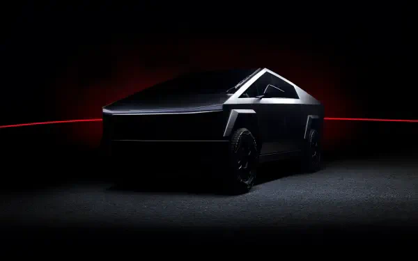 Tesla Cybertruck with angular design displayed in dramatic low light, set as a 4K Ultra HD PC desktop wallpaper and background.