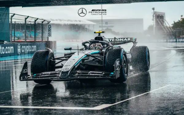 F1 Mercedes AMG Petronas car races on a wet track, captured in high-definition for a dynamic PC desktop wallpaper and background.